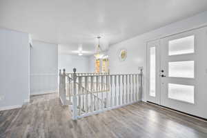 Entryway with wood-type flooring and a textured ceiling