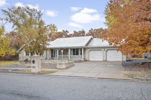 View of front of house featuring a porch and a garage