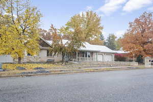 View of front of property with covered porch and a garage