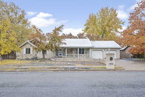 Single story home with a porch and a garage