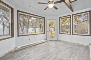 Spare room with beam ceiling, light hardwood / wood-style floors, and ceiling fan