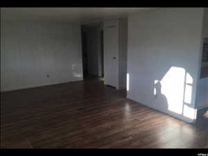 Empty room featuring dark hardwood / wood-style floors