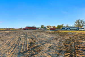 View of yard with a rural view and an outdoor structure