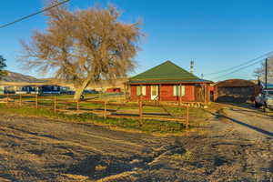 View of front facade featuring an outbuilding and a garage