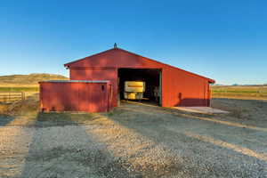 View of outdoor structure with a mountain view and a rural view