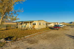 View of front of property featuring a mountain view and covered porch