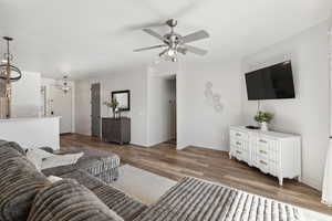 Living room with hardwood / wood-style flooring and ceiling fan