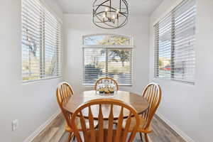 Dining area featuring hardwood / wood-style floors and a notable chandelier