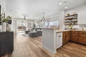 Kitchen with ceiling fan, sink, dishwasher, and a healthy amount of sunlight