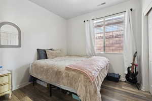 Bedroom with dark hardwood / wood-style floors