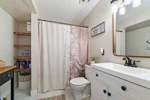 Bathroom with tile patterned floors, vanity, and toilet