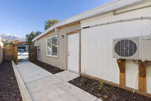 Property entrance with a mountain view and ac unit