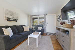 Living room with light hardwood / wood-style floors