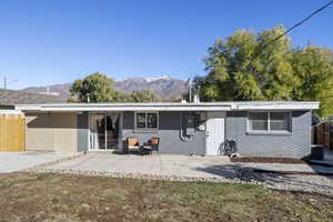 Back of property featuring a patio area and a mountain view