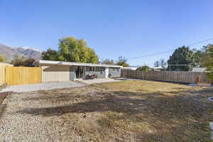 Rear view of property featuring a mountain view and a patio area