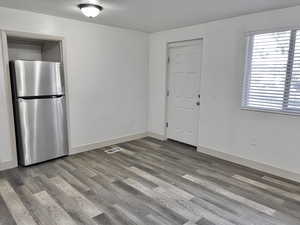 Interior space with dark hardwood / wood-style floors