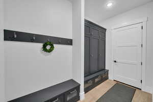 Mudroom with light hardwood / wood-style floors