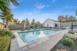 View of swimming pool featuring a patio area and an outdoor living space