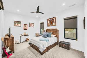 Bedroom featuring ceiling fan and light carpet