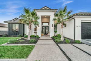 Doorway to property with a garage