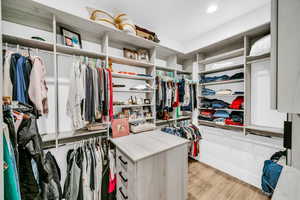 Spacious closet featuring light wood-type flooring