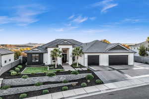 View of front of property featuring a mountain view and a garage