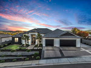 View of front of property with a mountain view and a garage