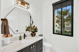 Bathroom with tile patterned flooring, vanity, and toilet