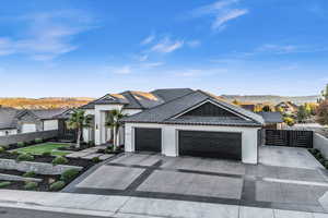 View of front facade with a mountain view and a garage