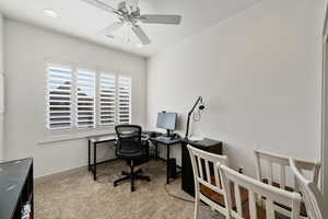 Carpeted home office with ceiling fan