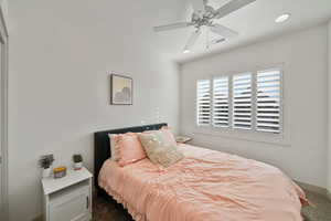 Carpeted bedroom with ceiling fan