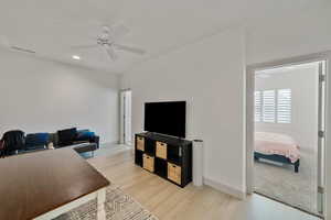 Home office featuring ceiling fan and light hardwood / wood-style flooring