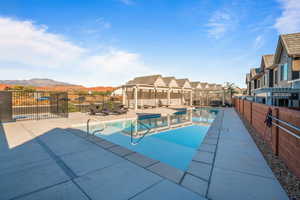 View of pool with a mountain view and a patio