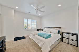 Bedroom with light colored carpet and ceiling fan