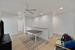 Interior space with ceiling fan and light hardwood / wood-style flooring