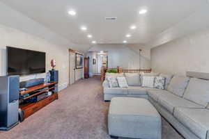 Living room featuring lofted ceiling and light carpet