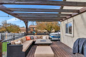 Wooden deck with a pergola, a grill, an outdoor living space, and a playground