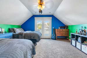 Bedroom featuring carpet, ceiling fan, access to exterior, and vaulted ceiling