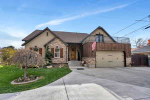 View of front of home with a balcony and a front yard