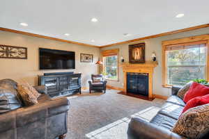 Living room with light carpet and crown molding