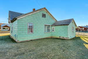 Rear view of house with a lawn