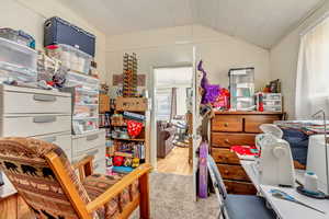 Bedroom featuring lofted ceiling, light wood-type flooring, and crown molding