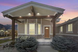 Exterior entry at dusk featuring a mountain view and a porch