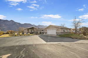 View of front of property featuring a mountain view and a garage