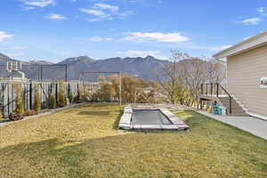 View of yard featuring a mountain view and a trampoline