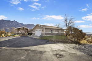 Ranch-style home featuring a mountain view and a garage