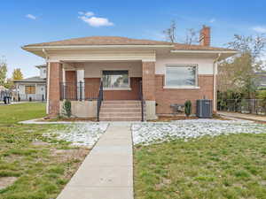 View of front of house featuring a porch,  a front yard.