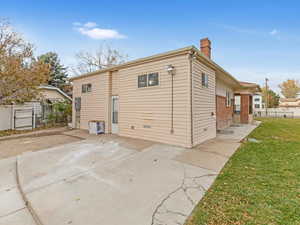 Rear view of property with a yard.