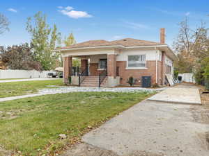 Bungalow-style home featuring covered porch & a front-lawn.