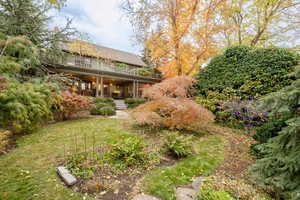 View of yard with a balcony